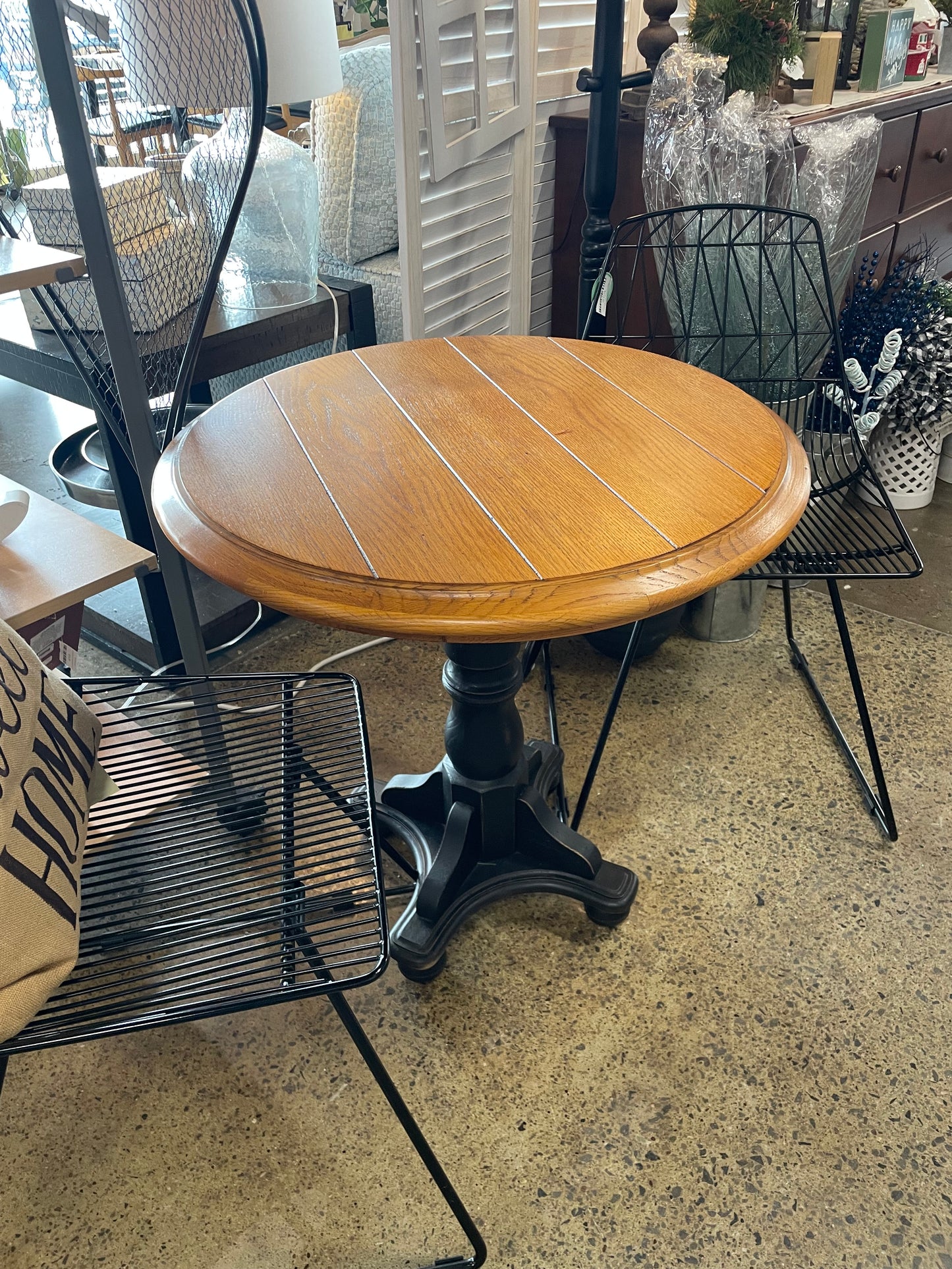 Wood top black pedestal accent table