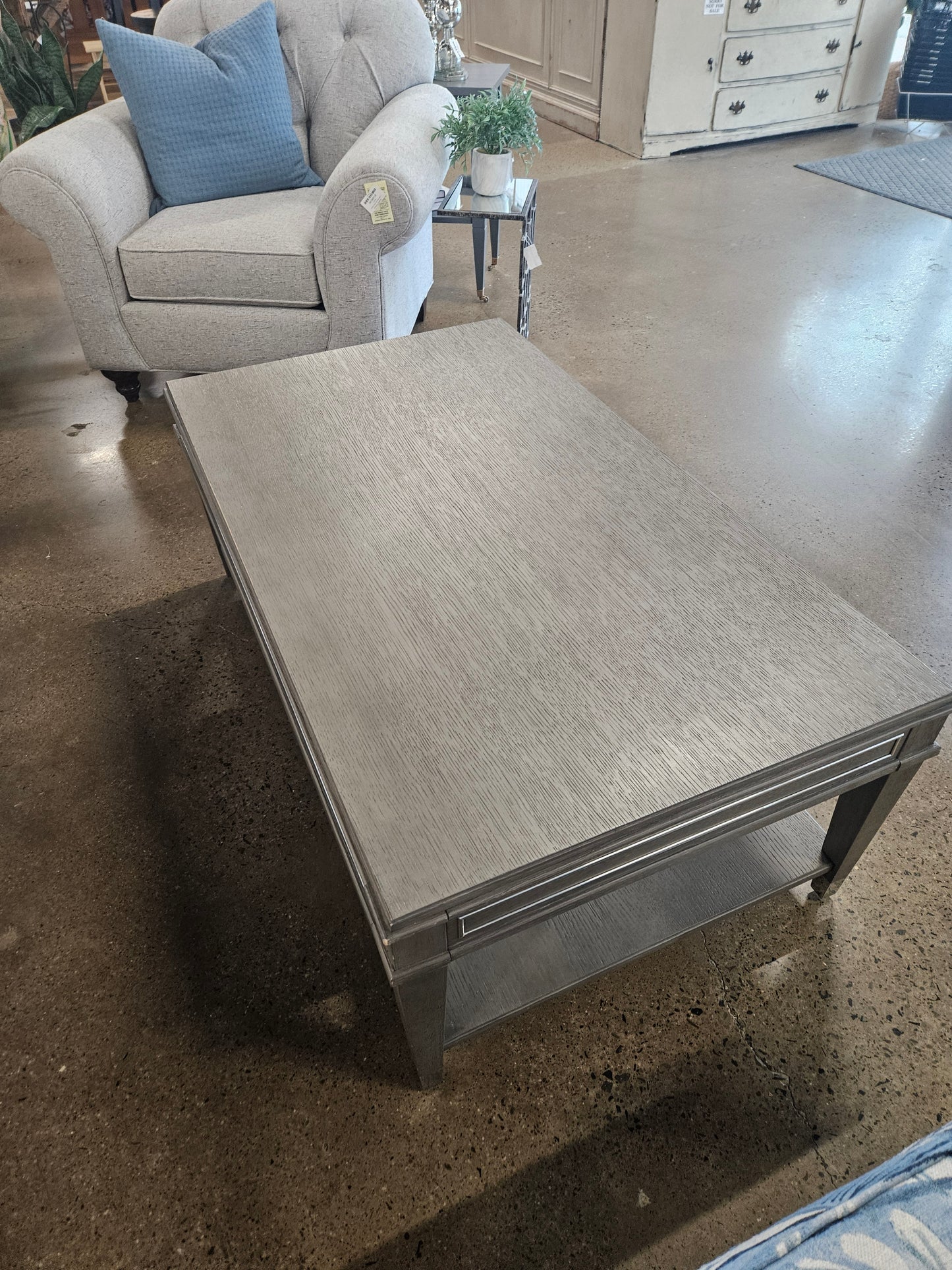 Gray wood coffee table with bottom wheels