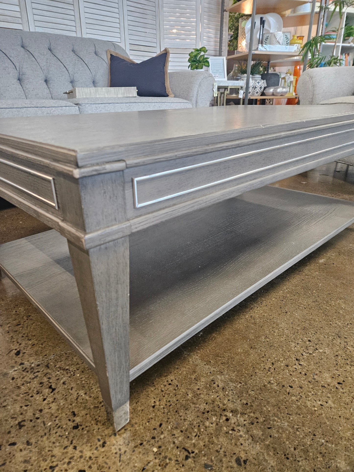 Gray wood coffee table with bottom wheels