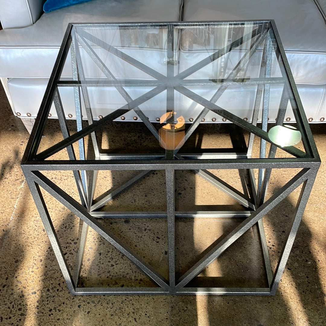 Grey and silver colored metal glass top table