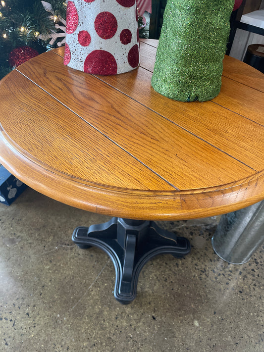 Wood top black pedestal accent table