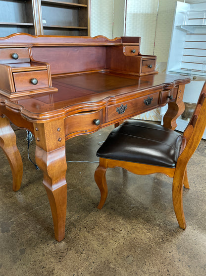 Wooden desk with drawers and chair