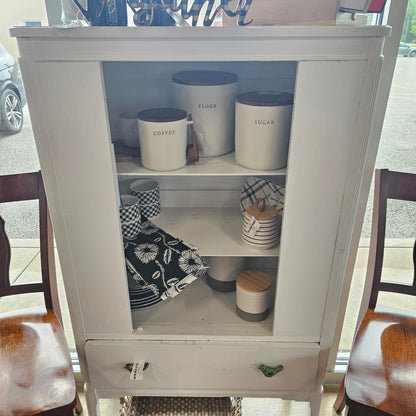 White cabinet with bird handles