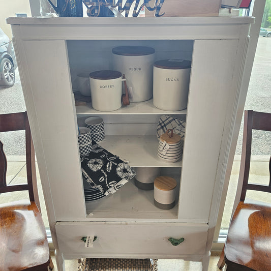 White cabinet with bird handles