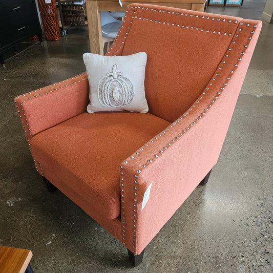 Orange accent armchair with nailhead trim