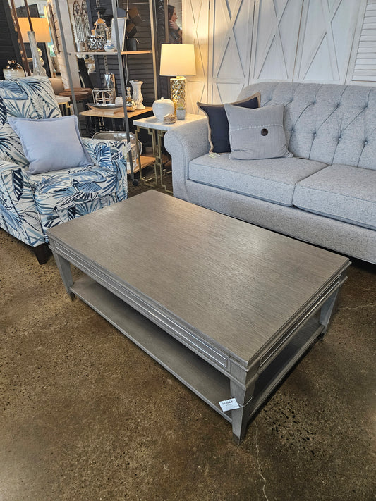 Gray wood coffee table with bottom wheels