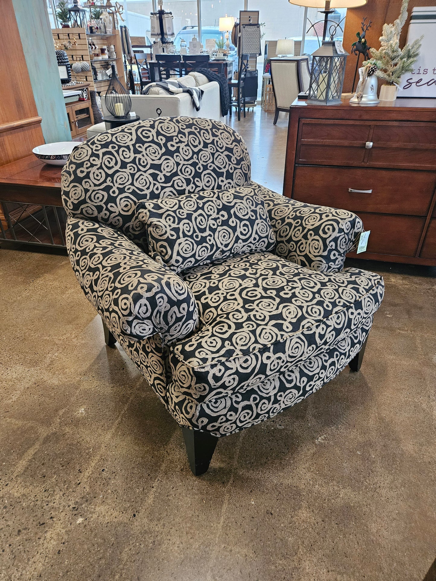 Dark armchair with silver swirls
