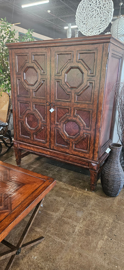 Red oak armoire with carved cabinet doors