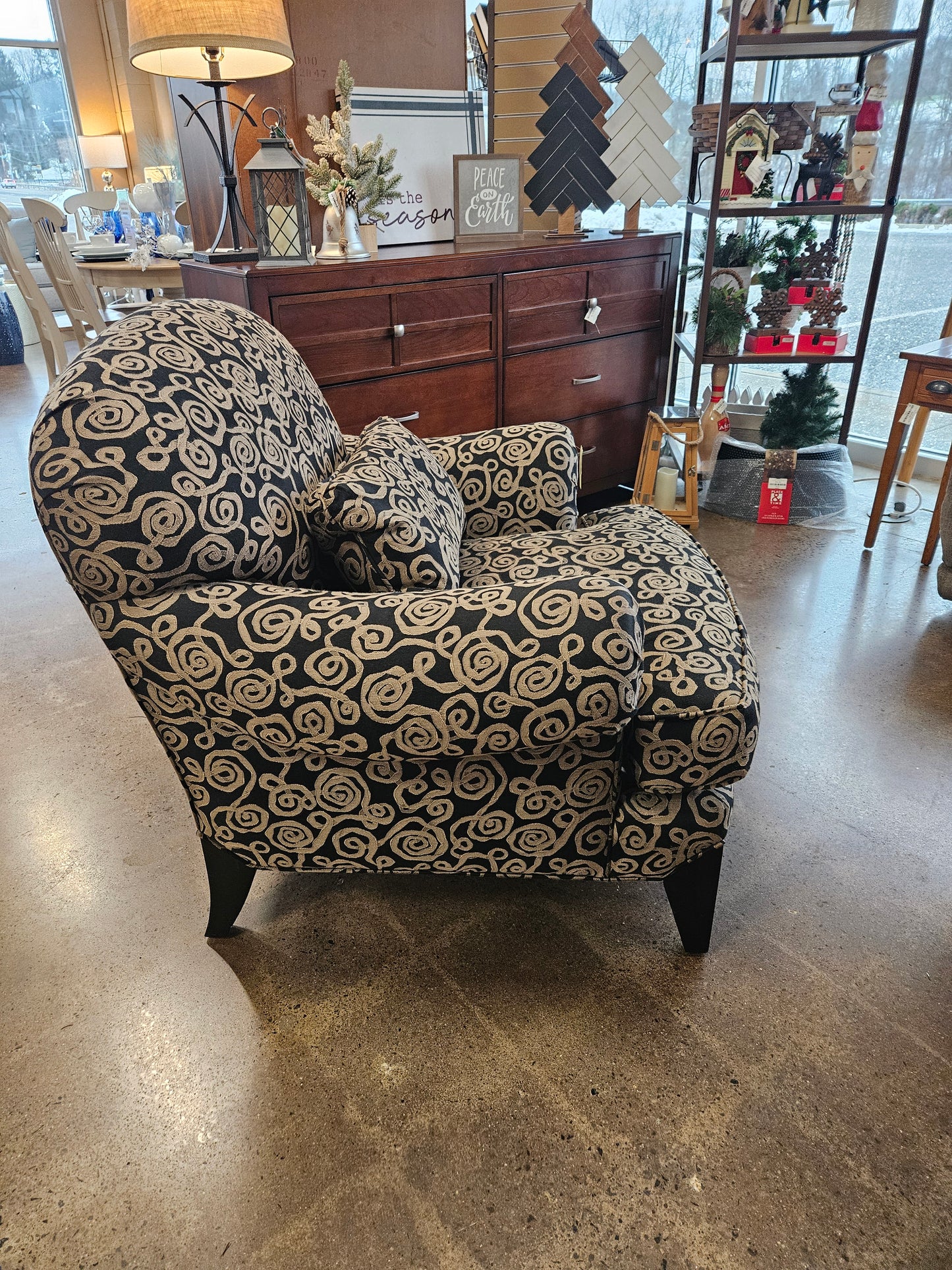 Dark armchair with silver swirls