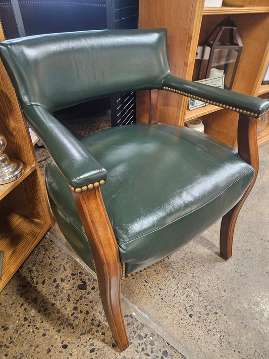 Green leather like chair with nailhead trim