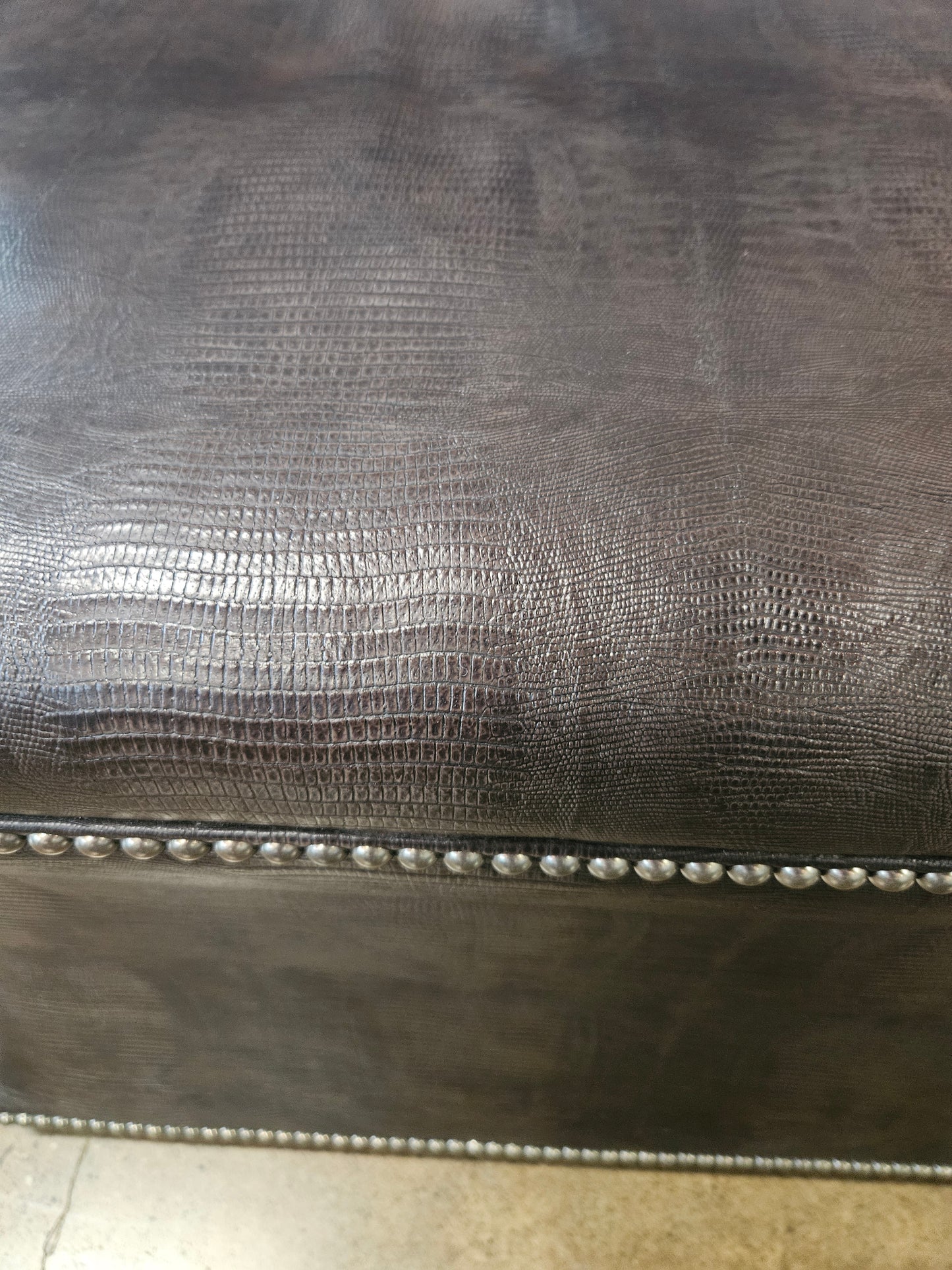 Brown patterned ottoman  with silver nailhead trim