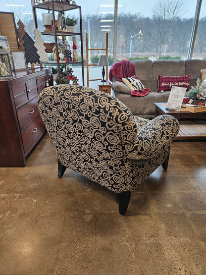Dark armchair with silver swirls