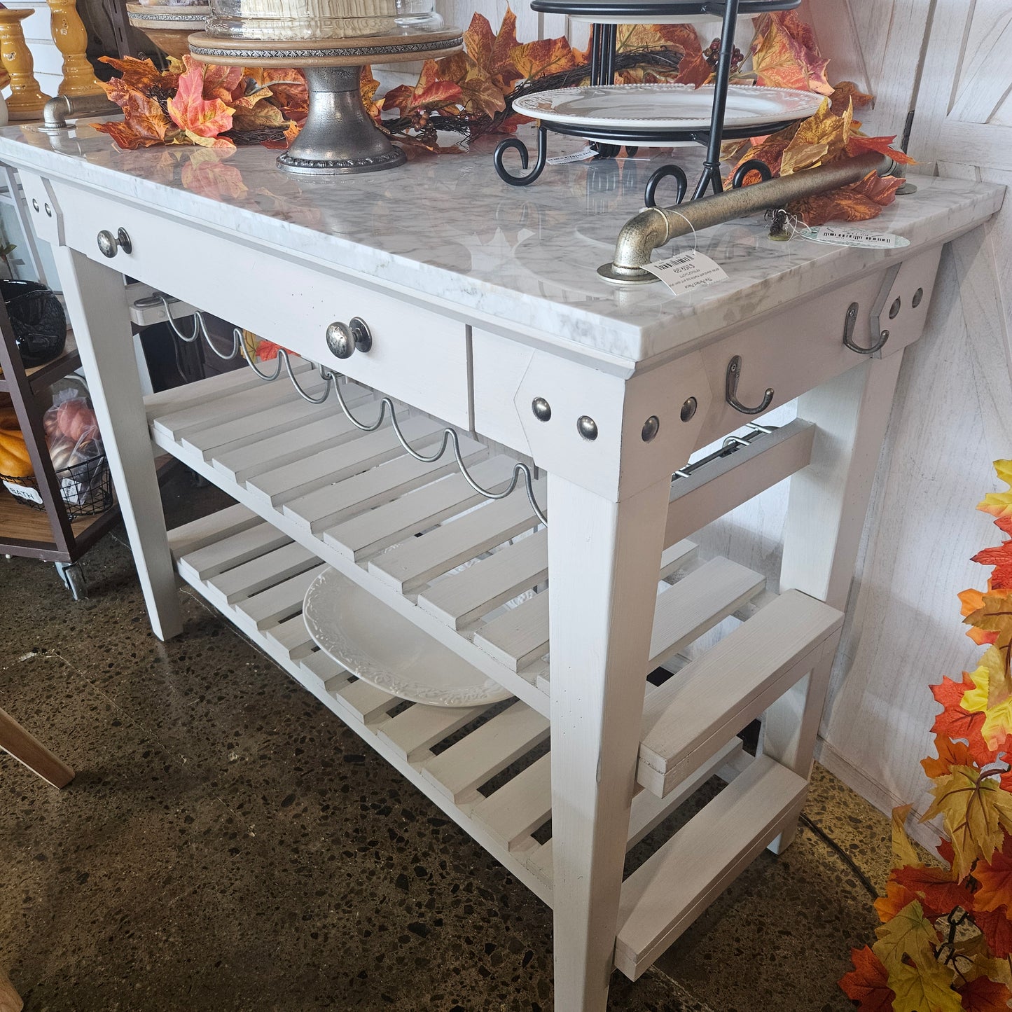 White island with marble top and open shelves
