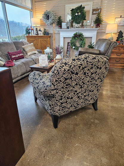 Dark armchair with silver swirls