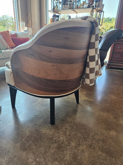 Curved beige accent chair with contoured wood veneer back